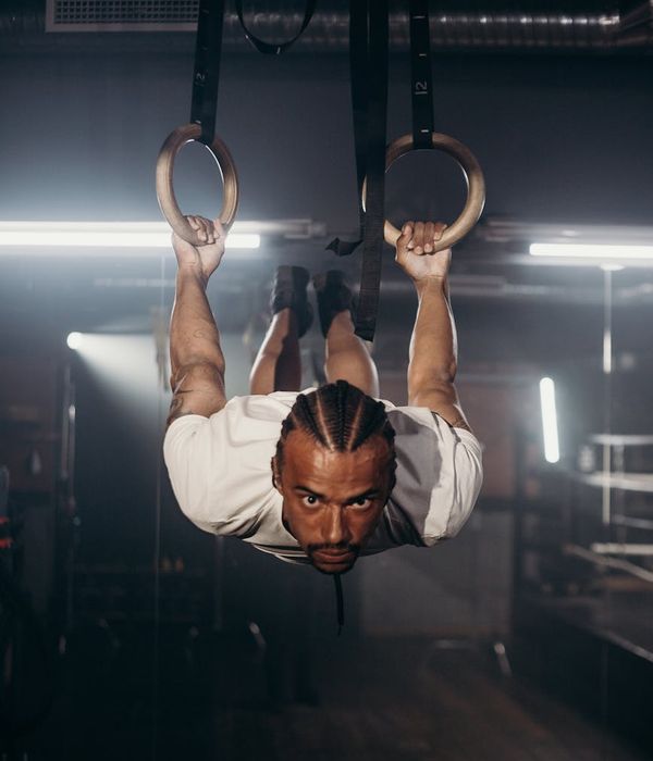 Man performing a powerful core exercise in a dimly lit, focused environment.