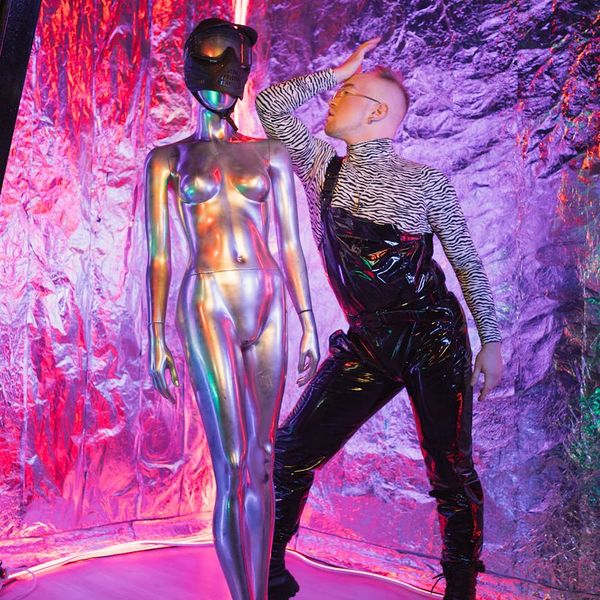 Silhouette of a man in a balanced pose against a warm, glowing background.